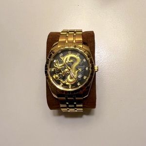 Gold watch with dragon design